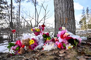 Flowers and toys lie on the ground near the site of a mass shooting